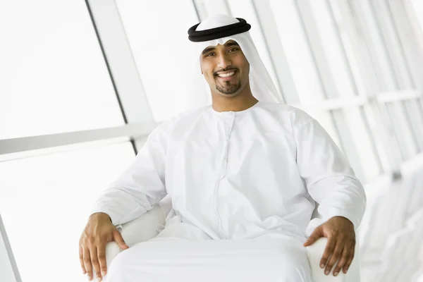 A Middle Eastern businessman sitting in a chair — Stock Photo, Image