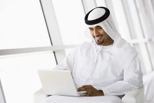 A Middle Eastern businessman sitting with a laptop — Stock Photo, Image