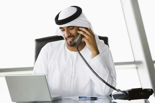 A Middle Eastern businessman talking on the telephone — Stock Photo, Image