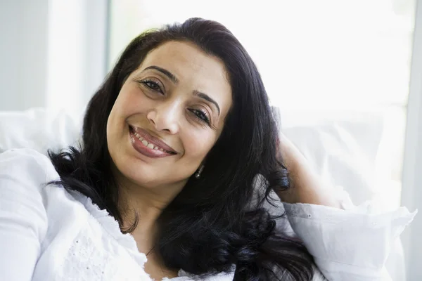 A Middle Eastern woman sitting at home — Stock Photo, Image