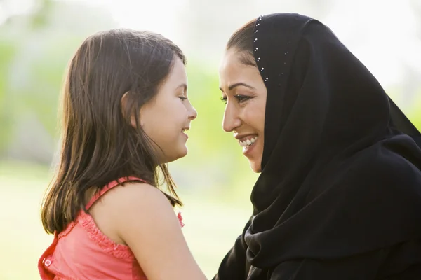 一个中东的女人和她的女儿坐在一个公园 — 图库照片