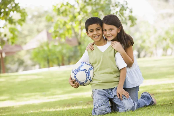 Due bambini che giocano a calcio nel parco — Foto Stock