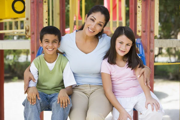 Mother and children in playground — Stock Photo, Image