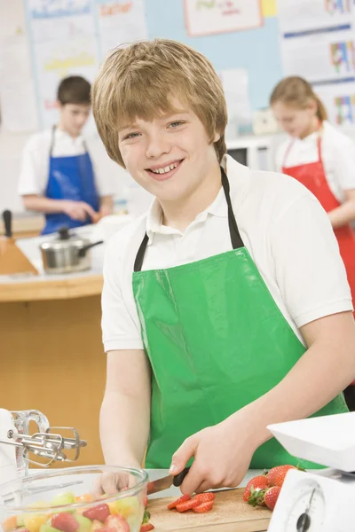 Schoolboy at school in a cooking class — Stock Photo, Image