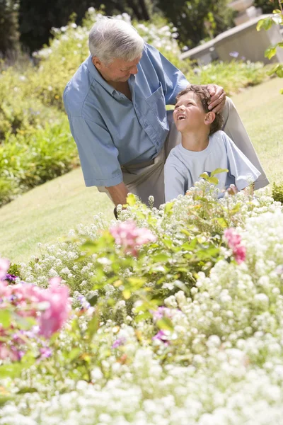 Grandfather and grandson working in the garden — Stock Photo, Image