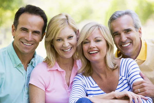 Two couples outdoors smiling — Stock Photo, Image