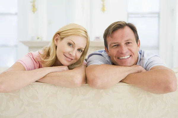 Couple relaxing in living room and smiling — Stock Photo, Image