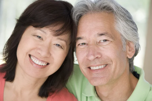 Couple relaxing indoors and smiling — Stock Photo, Image