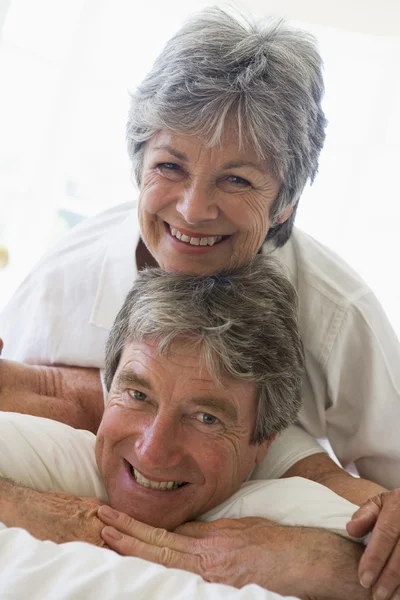 Couple relaxing in bedroom and smiling — Stockfoto