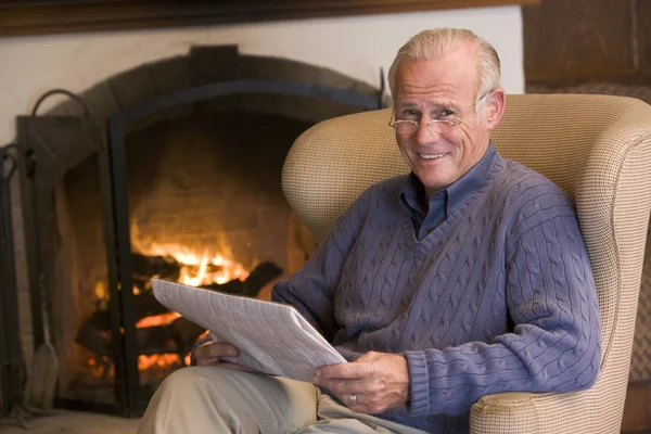 Muž Sedí Obývacím Pokoji Krb Úsměvem Noviny — Stock fotografie