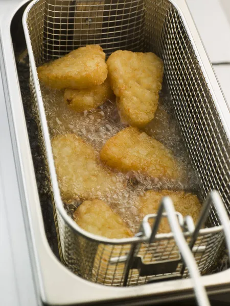 Hash Browns being Deep Fried in Corn Oil — Stock Photo, Image