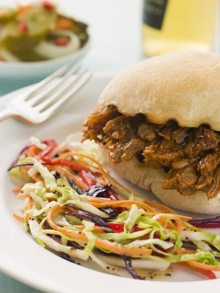 Pulled Pork and Barbeque Sauce Roll with Seeded Slaw and Gherkin — Stock Photo, Image