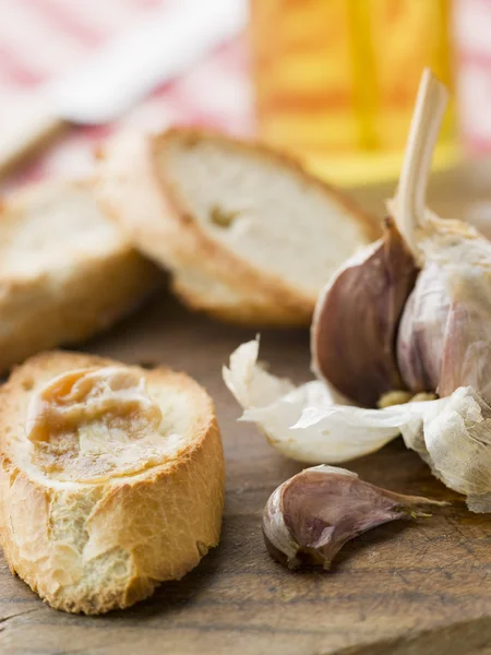 Cloves of Roasted Garlic spread on Toasted baguette — Stock Photo, Image