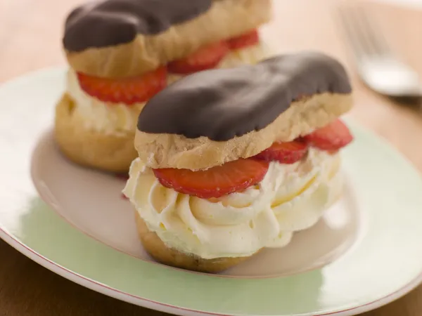 Chocolate and Strawberry filled eclairs — Stock Photo, Image