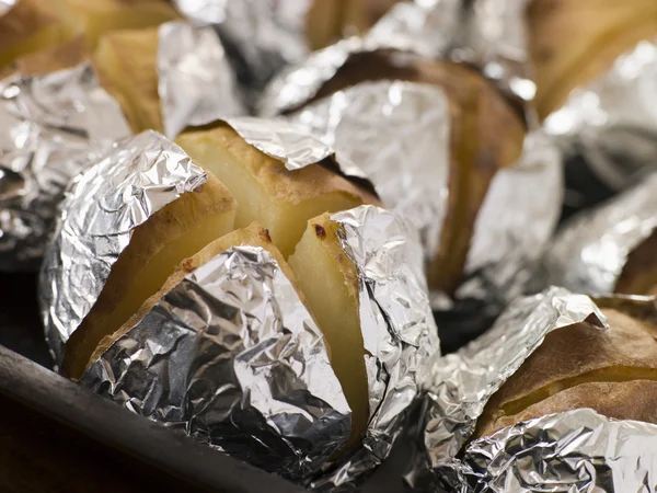 Tray of Jacket Potatoes Wrapped in Foil — Stock Photo, Image