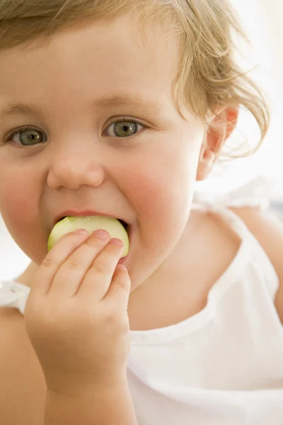 Baby Indoors Eating Apple — Stock Photo, Image