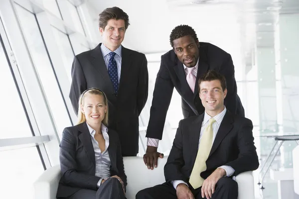 Cuatro Empresarios Vestíbulo Oficinas Sonriendo —  Fotos de Stock
