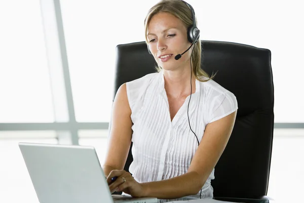 Businesswoman Sitting Office Wearing Headset Using Laptop — Stock Photo, Image