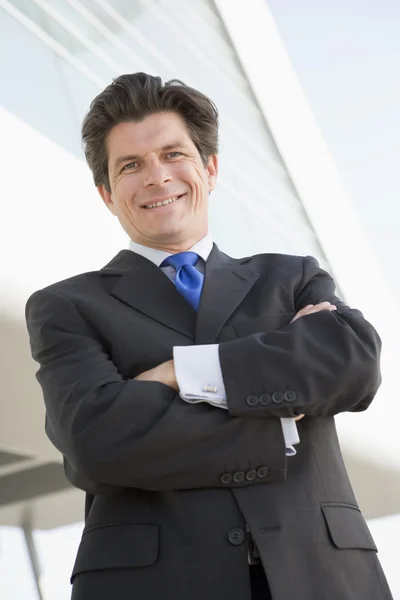 Uomo d'affari in piedi all'aperto costruendo sorridente — Foto Stock