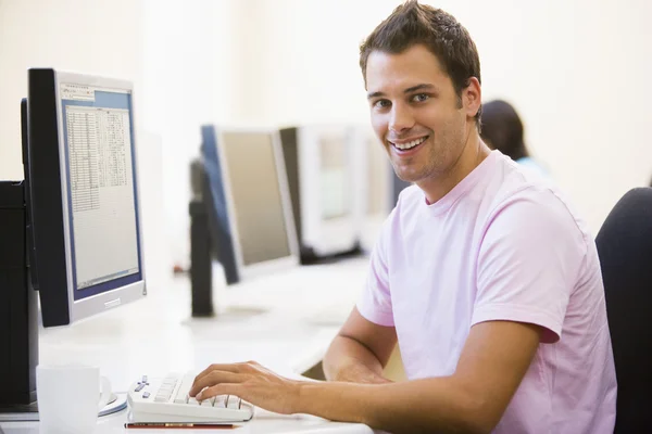 Stock image Man in computer room smiling