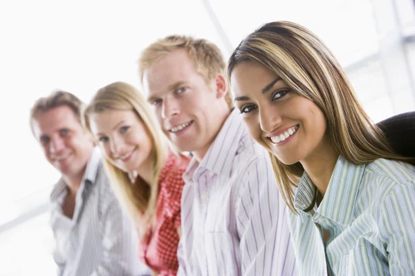 Cuatro Empresarios Sentados Interior Sonriendo —  Fotos de Stock