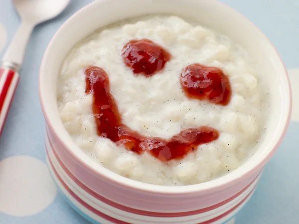Bowl of Creamed Rice Pudding with a Strawberry Jam Face — Stock Photo, Image