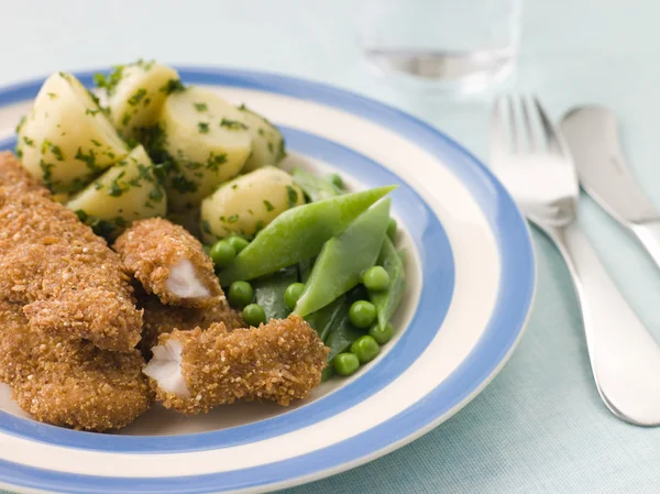 Goujons de pollo con papas nuevas con mantequilla de hierbas y Vegeta Verde —  Fotos de Stock