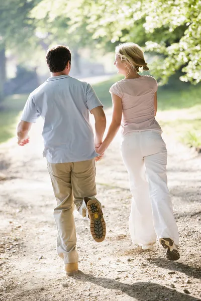 Couple Running Outdoors Holding Hands — Stock Photo, Image