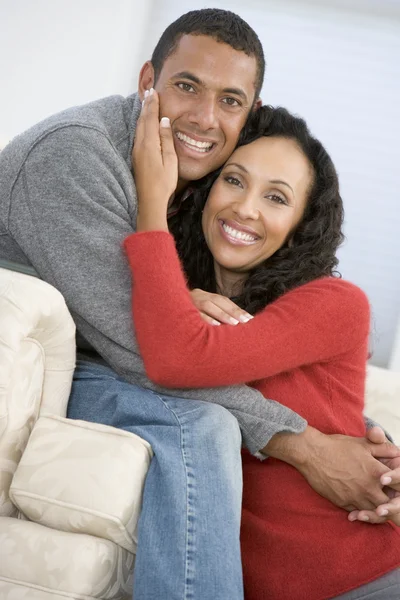 Couple in living room smiling — Stock Photo, Image