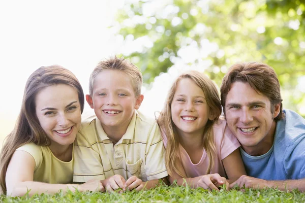 Family Lying Outdoors Smiling — Stok fotoğraf