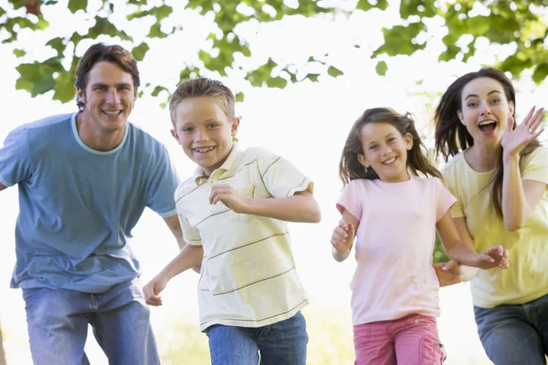 Family Running Outdoors Smiling — Stock Photo, Image