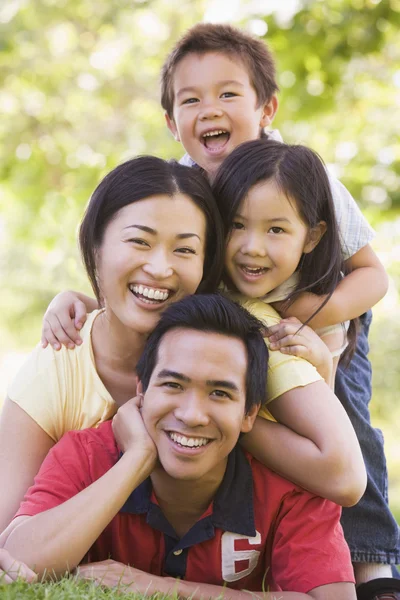 Family Lying Outdoors Smiling — Stock Photo, Image