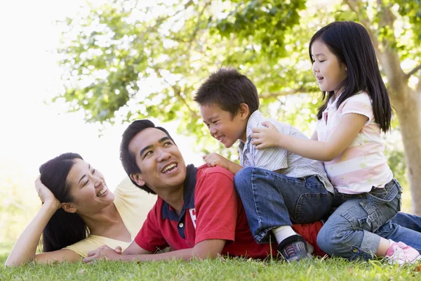 Family Lying Outdoors Being Playful Smiling — Stock Photo, Image