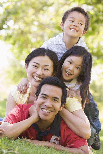 Family Lying Outdoors Smiling — Stock Photo, Image
