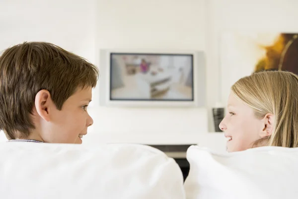 Ung pojke och flicka i vardagsrum med platt-TV — Stockfoto