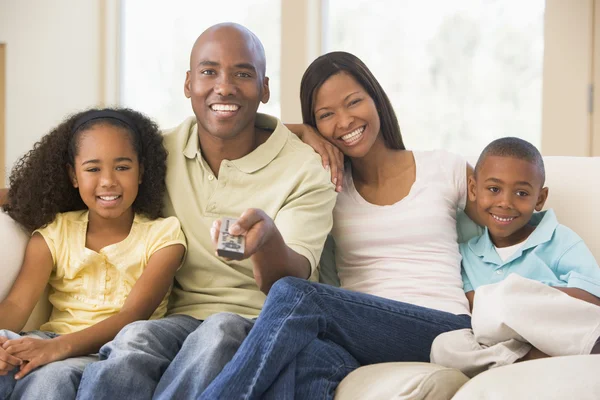 Family Sitting Living Room Remote Control Smiling — Stock Photo, Image