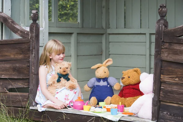 stock image Young girl in shed playing tea and smiling