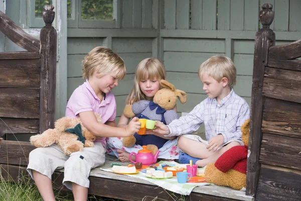 Three Young Children Shed Playing Tea Smiling — Stock Photo, Image