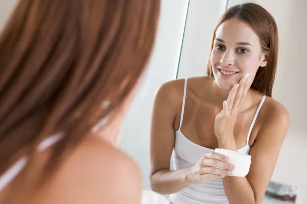 Woman Bathroom Applying Face Cream Smiling — Stock Photo, Image
