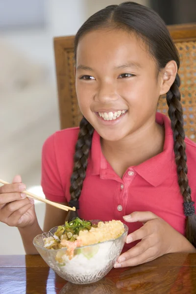 Young girl in dining room eating Chinese food smiling — Stock Photo, Image