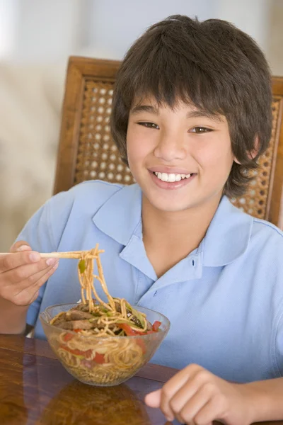 Young boy in dining room eating chinese food smiling — Stock Photo, Image