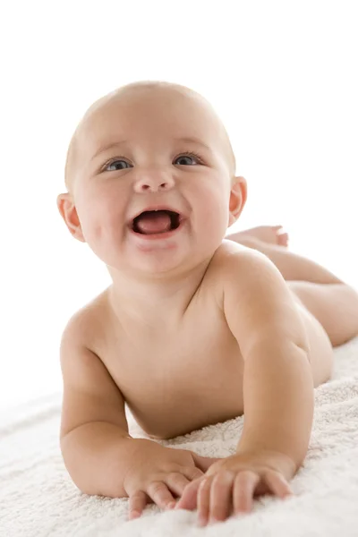 Bebé acostado sonriendo Fotos de stock