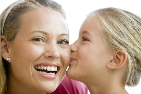 Young Girl Kissing Smiling Woman Stock Photo