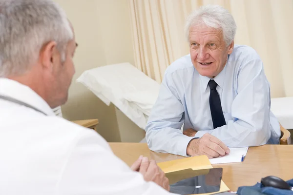 Man in doctor's office smiling Stock Picture