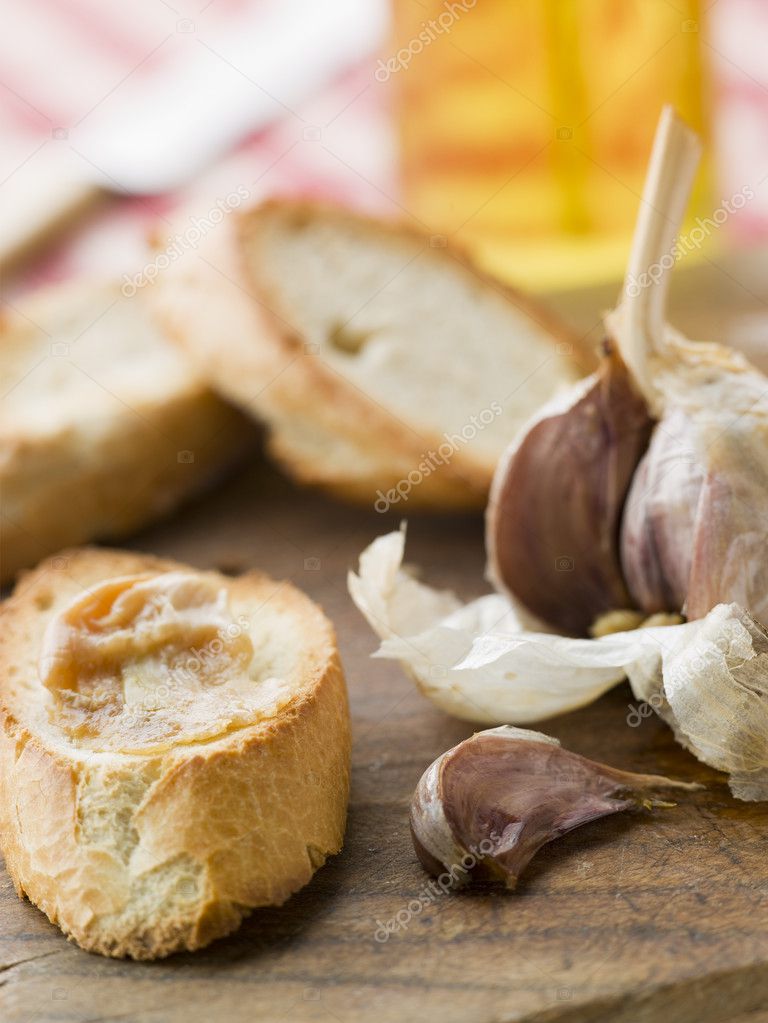 Cloves of Roasted Garlic spread on Toasted baguette — Stock Photo