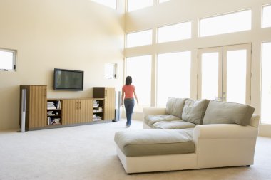 Woman walking through living room clipart