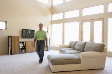 Man walking through living room clipart