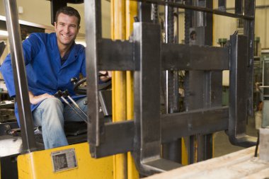 Warehouse worker in forklift clipart