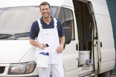 Painter standing with van smiling clipart