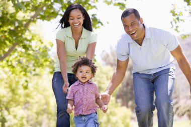 Family running outdoors smiling clipart